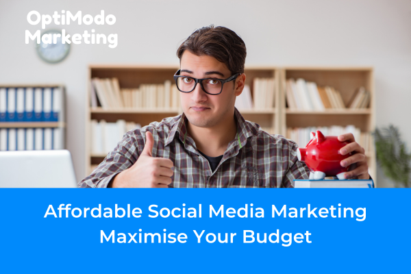 Man giving a thumbs up next to a piggy bank on top of a stack of books, symbolizing budget-friendly social media marketing strategies.